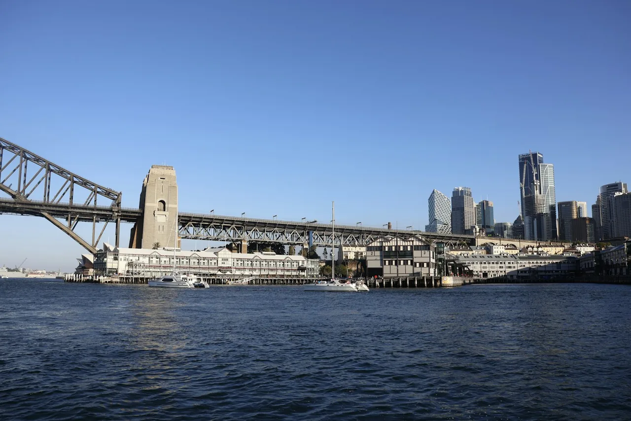 Sydney Harbour Bridge and the city skyline, photographed from the water.